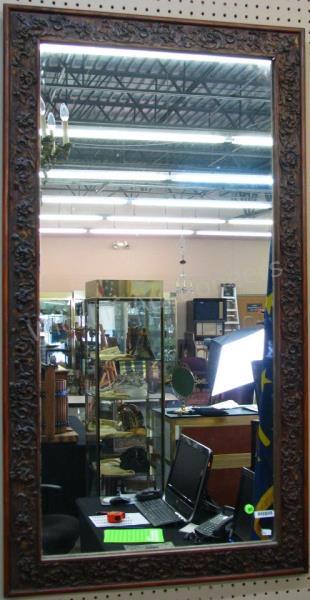 Appraisal: An antique wall mirror with carved wooden frame x