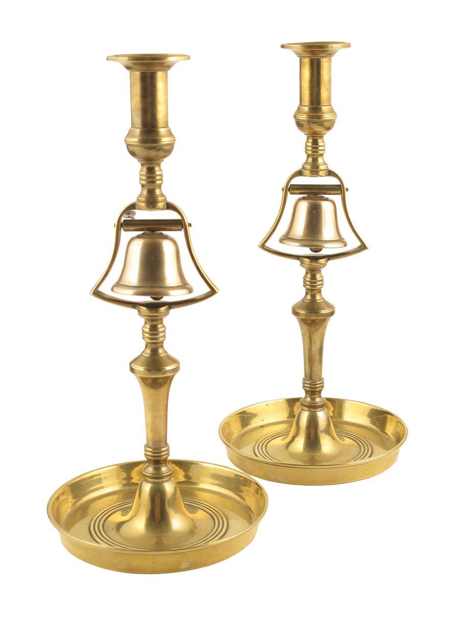 Appraisal: A pair of brass and bell metal candlesticks