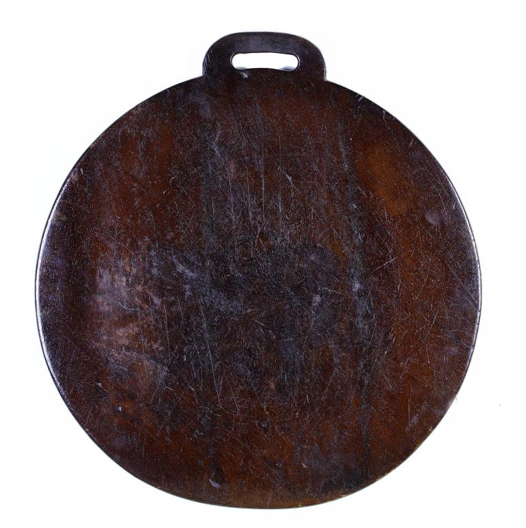 Appraisal: A FRUITWOOD BREAD BOARD PROBABLY ENGLISH OR WELSH of plain