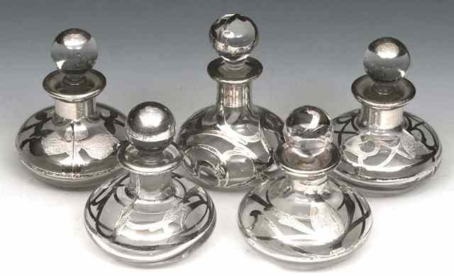 Appraisal: A GROUP OF FIVE SILVER AND GLASS OVERLAID PERFUME BOTTLES