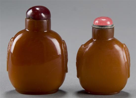 Appraisal: Two Chinese glass snuff bottles imitating carnelian c With relief