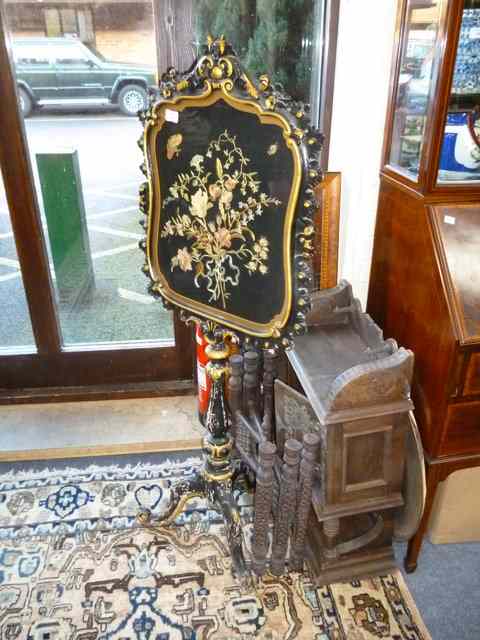 Appraisal: A VICTORIAN EBONISED PARCEL GILT POLE SCREEN the shaped screen