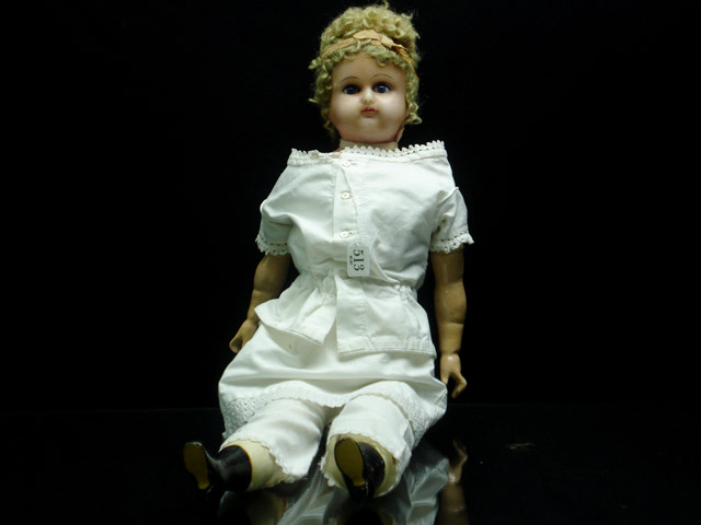 Appraisal: A poured wax head and shoulder plate Mama doll Mama