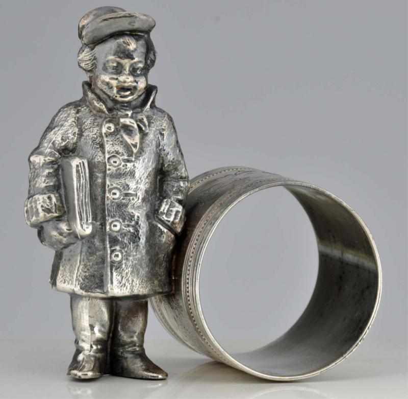 Appraisal: Boy with Newspaper Standing by Napkin Ring Condition Excellent Size