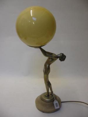 Appraisal: AN ART DECO SILVERED FIGURAL TABLE LAMP in the style