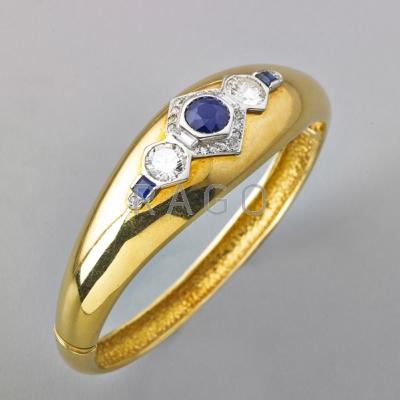 Appraisal: DIAMOND AND SAPPHIRE K GOLD HINGED BRACELET Two transitional cut