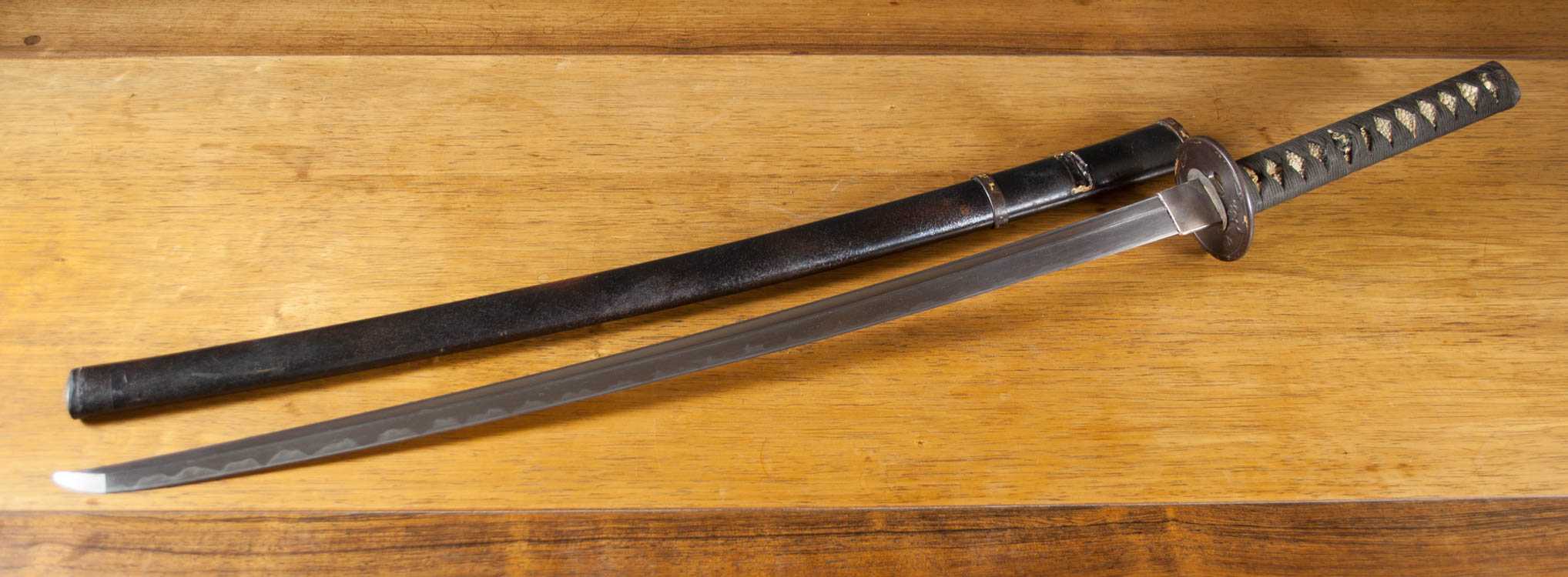 Appraisal: JAPANESE SAMURAI SWORD KATANA shallow curved blade with wavy temper