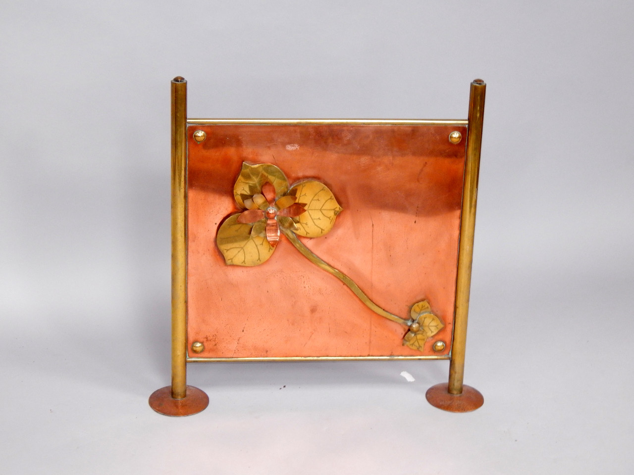 Appraisal: An Arts and Crafts copper and brass fire screen decorated