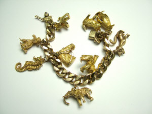 Appraisal: A ct gold flat curb link charm bracelet Fitted with