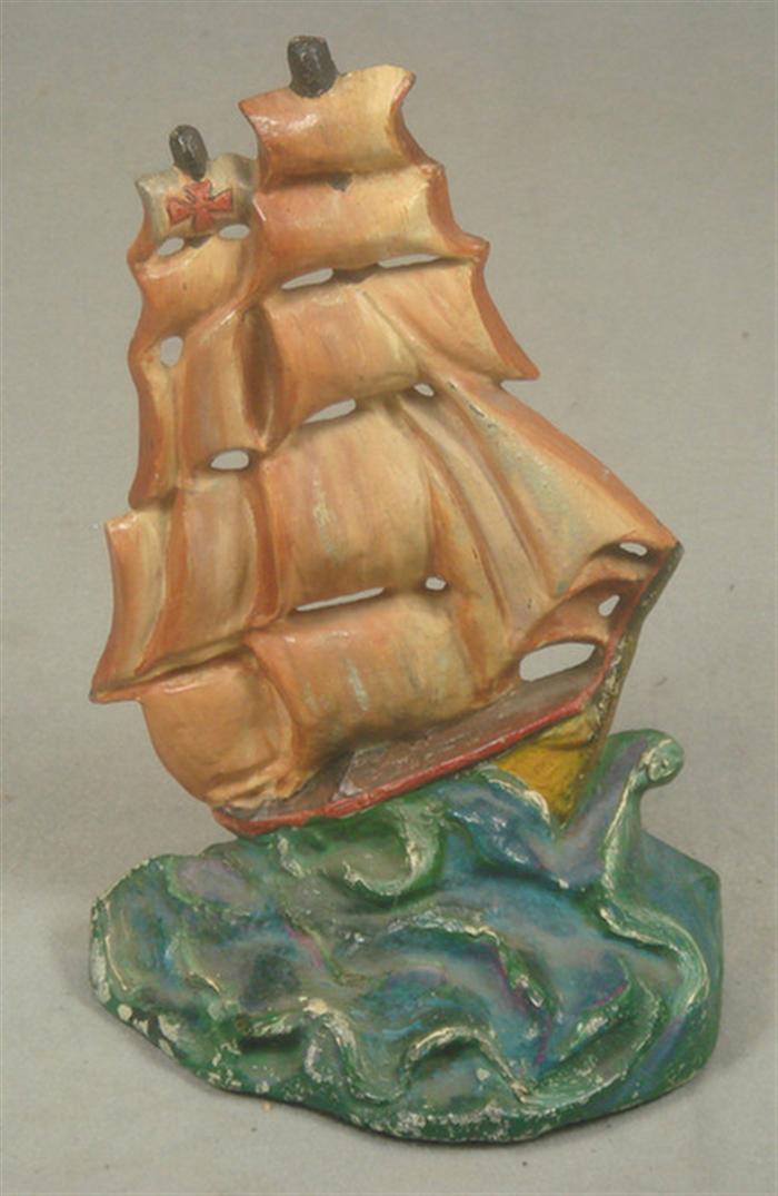 Appraisal: Cast iron doorstop pirate ship with ironside cross on stormy