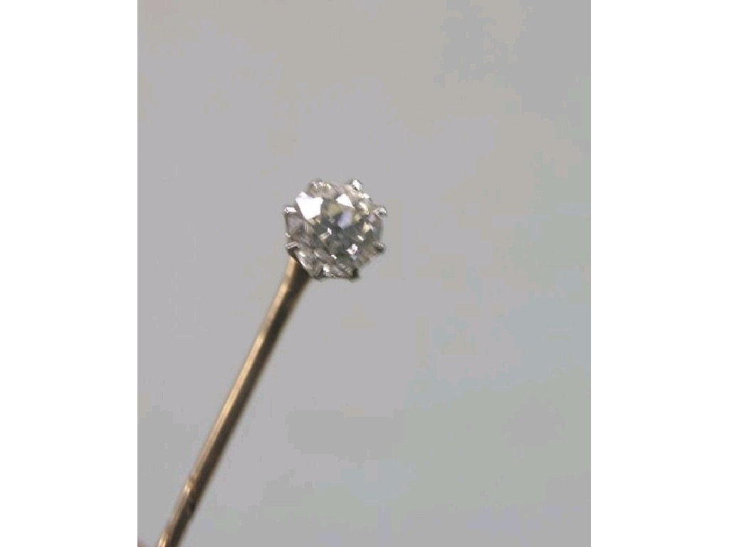 Appraisal: A diamond stick pin single stone in claw setting approximately