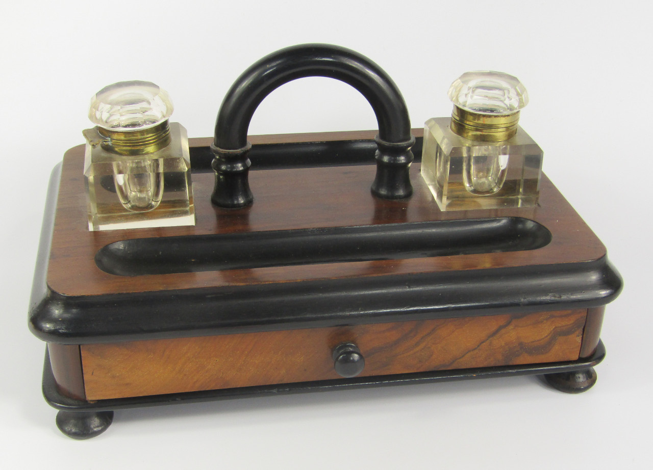 Appraisal: A Victorian walnut and ebonised desk stand with two brass