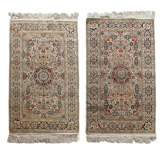 Appraisal: A NEAR PAIR OF ORIENTAL SILK WHITE GROUND RUGS each