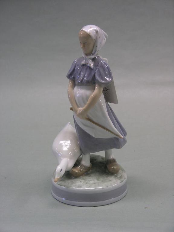 Appraisal: A Royal Copenhagen figure of a farmhand female standing beside