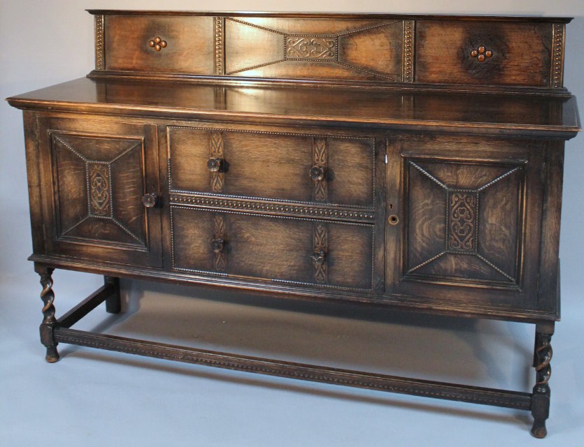 Appraisal: An early thC oak sideboard with a carved panel back