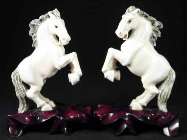 Appraisal: Pair of Chinese carved ivory rearing horses Both have black