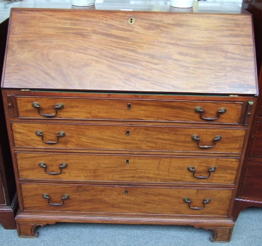 Appraisal: A George III mahogany bureau the fall enclosing a fitted