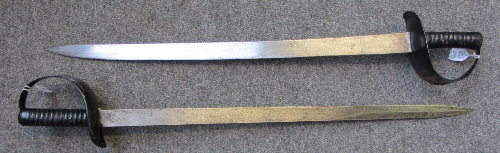 Appraisal: Two Victorian short swords with slightly curved steel blade and