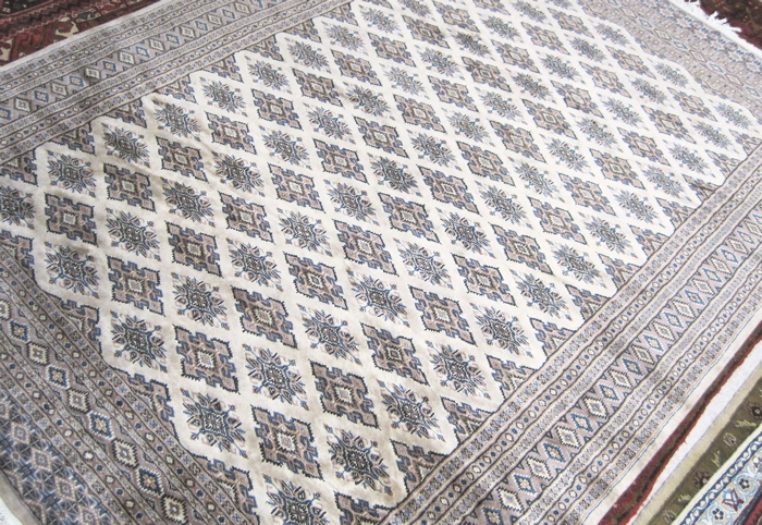 Appraisal: PAKISTANI BOKHARA CARPET featuring a field of repeating diamond-shaped Turkoman