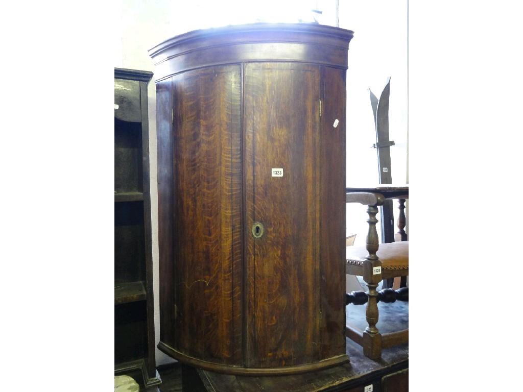 Appraisal: A th century oak bow front corner cupboard enclosed by