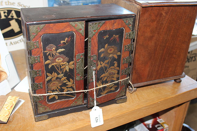 Appraisal: A SMALL LAQUERED CHINESE TABLE-TOP CABINET with panelled doors decorated