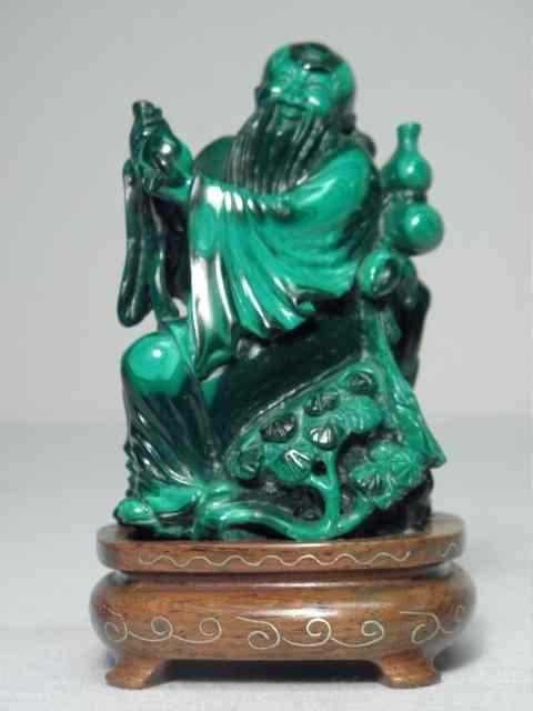 Appraisal: Chinese carving in green Malachite On wooden stand and depicts