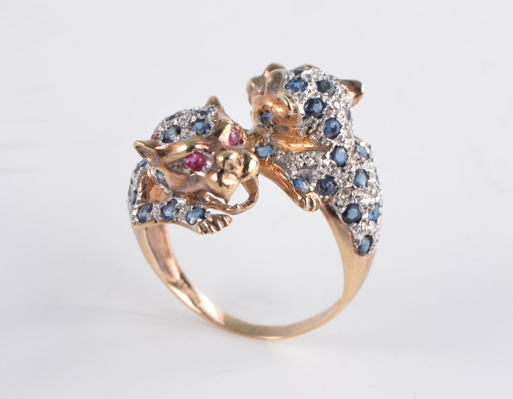 Appraisal: SAPPHIRE DIAMOND LEOPARD RING k yellow gold double leopard bypass