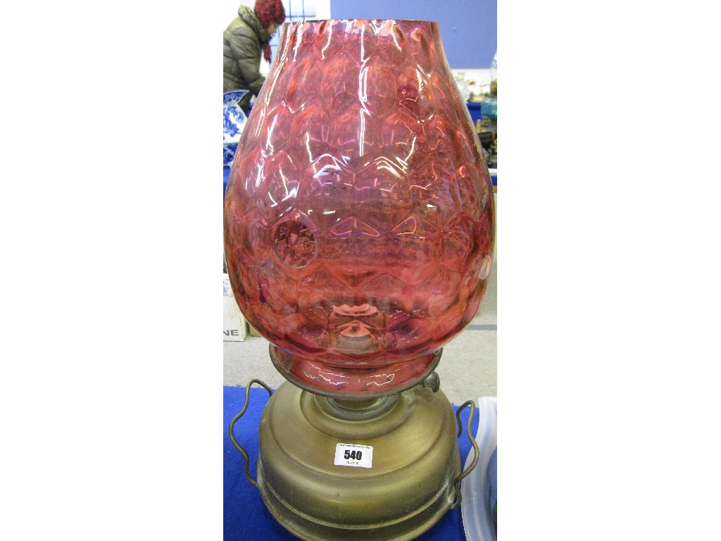 Appraisal: Paraffin lamp with large cranberry honeycomb glass shade