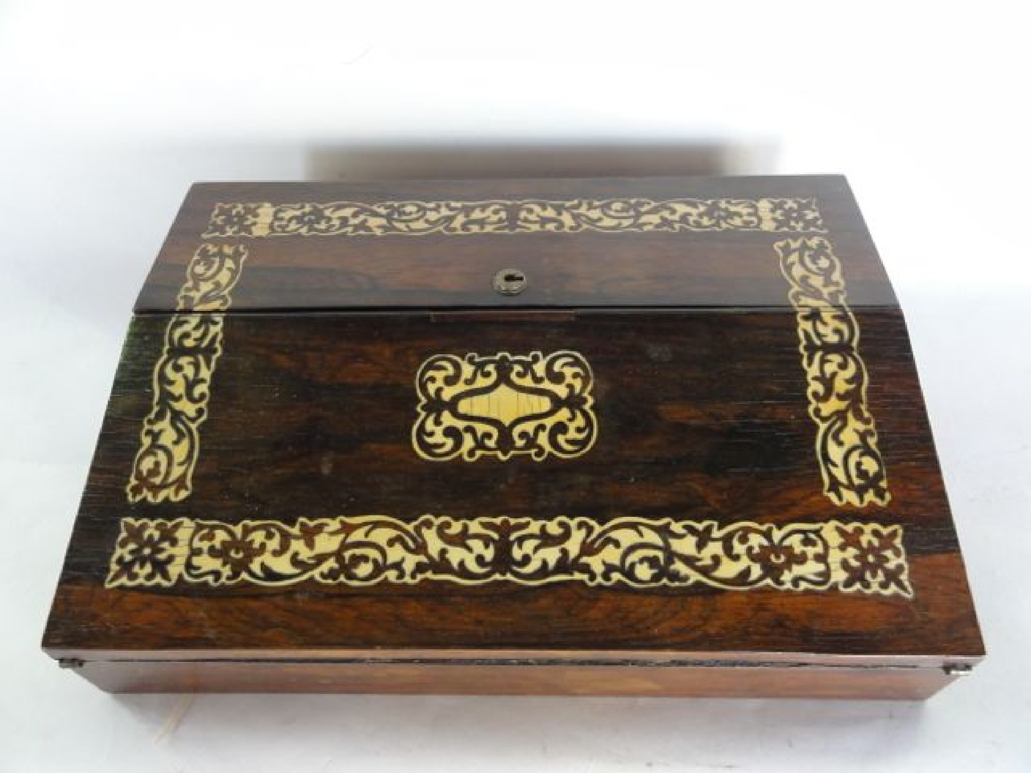 Appraisal: A small Victorian rosewood veneered writing slope the hinged and