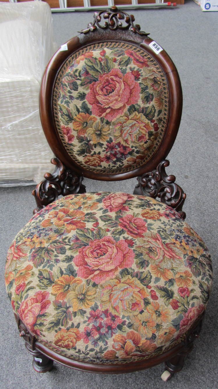 Appraisal: A Victorian walnut nursing chair with pierced and carved decoration