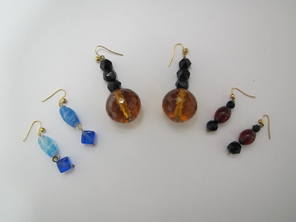 Appraisal: Pair multi-faceted amber and jet earrings another smaller pair and