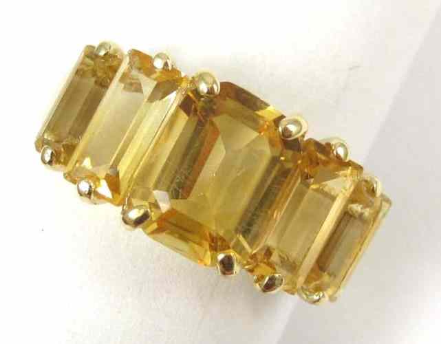 Appraisal: CITRINE AND FOURTEEN KARAT GOLD RING set with a pair