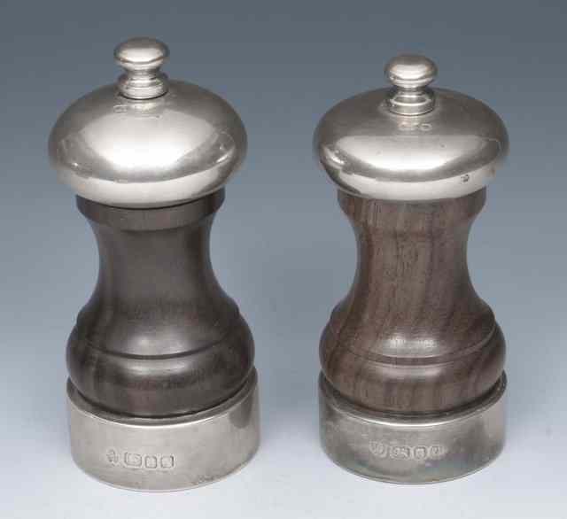 Appraisal: TWO SILVER MOUNTED TURNED WOODEN PEPPER GRINDERS of waisted form