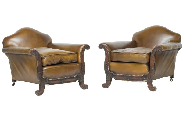 Appraisal: A pair of early th century leather upholstered easy armchairs