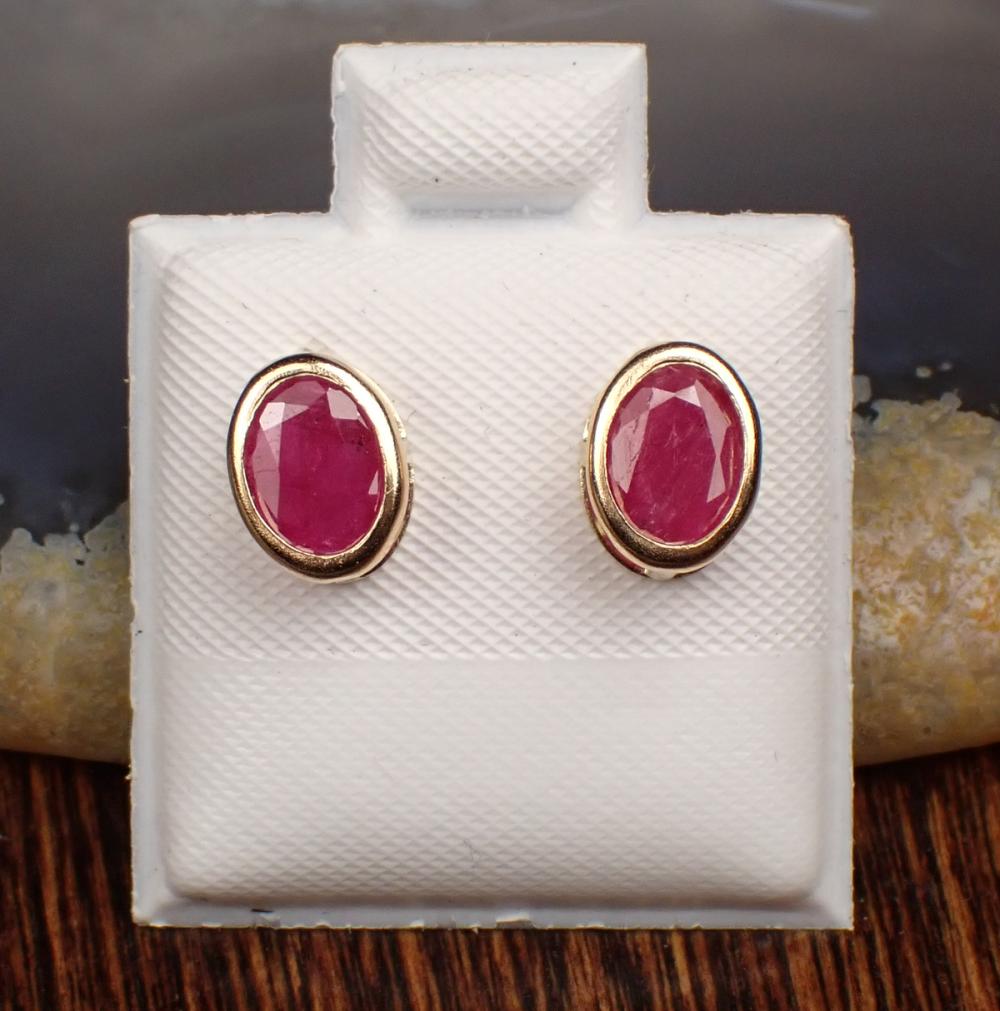 Appraisal: PAIR OF RUBY AND FOURTEEN KARAT GOLD EAR STUDS each