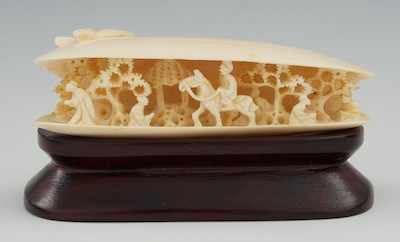 Appraisal: A Carved Ivory Clam Shell with Figures Inside The elongated