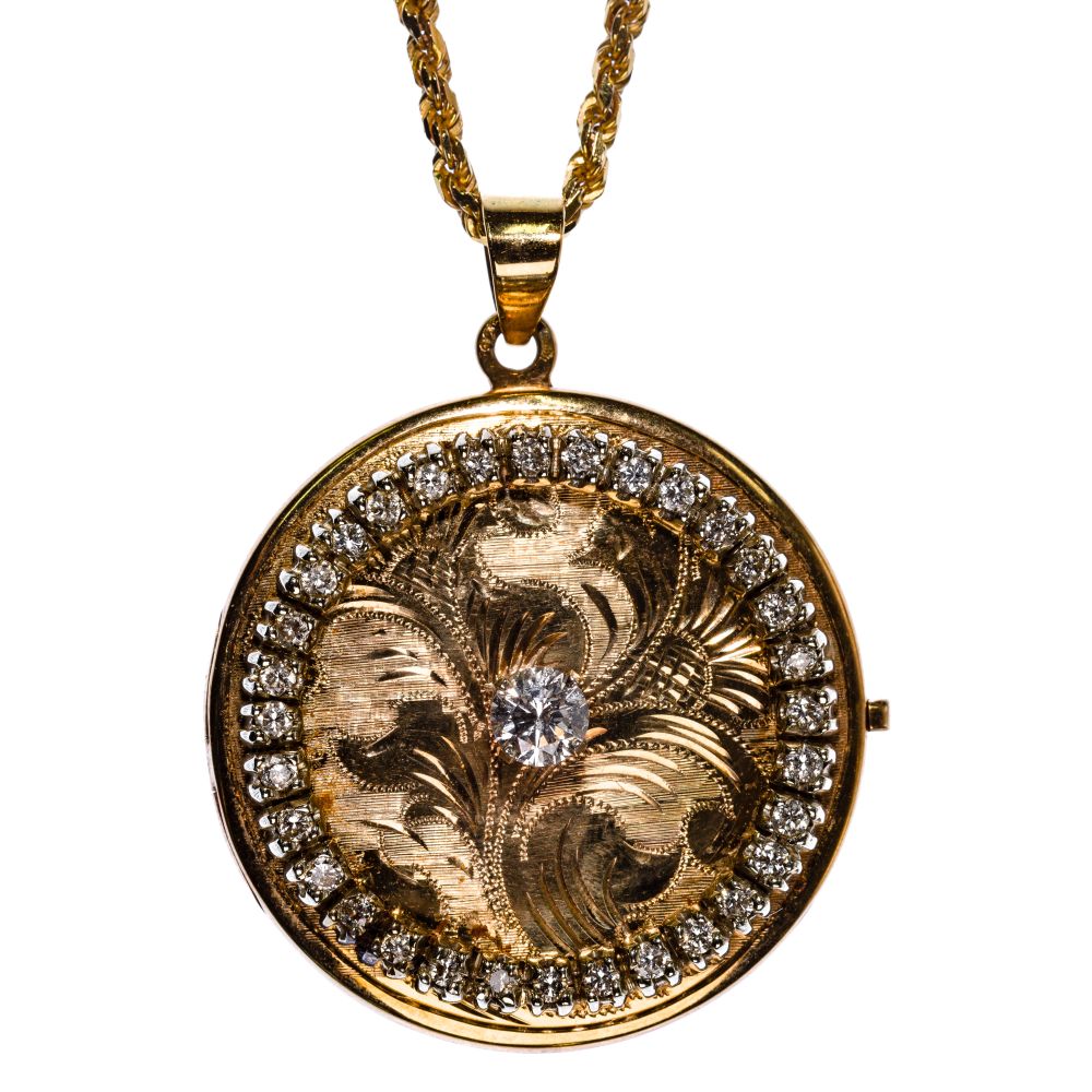 Appraisal: K YELLOW GOLD AND DIAMOND LOCKET ON TWISTED ROPE NECKLACEHaving