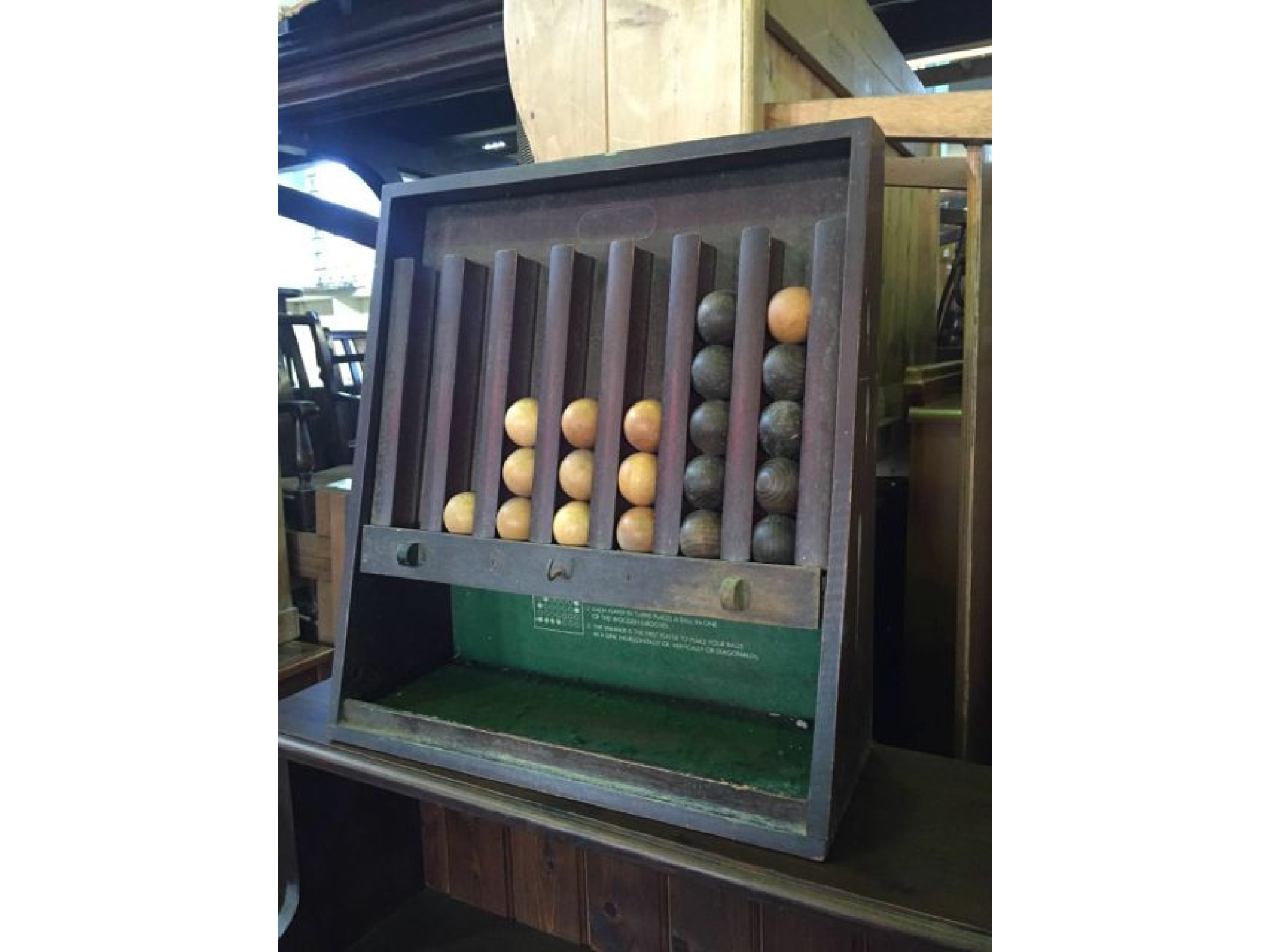 Appraisal: A vintage game assembly containing a quantity of timber balls