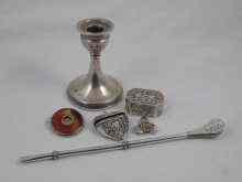 Appraisal: A silver dwarf candlestick a silver heart shaped locket a