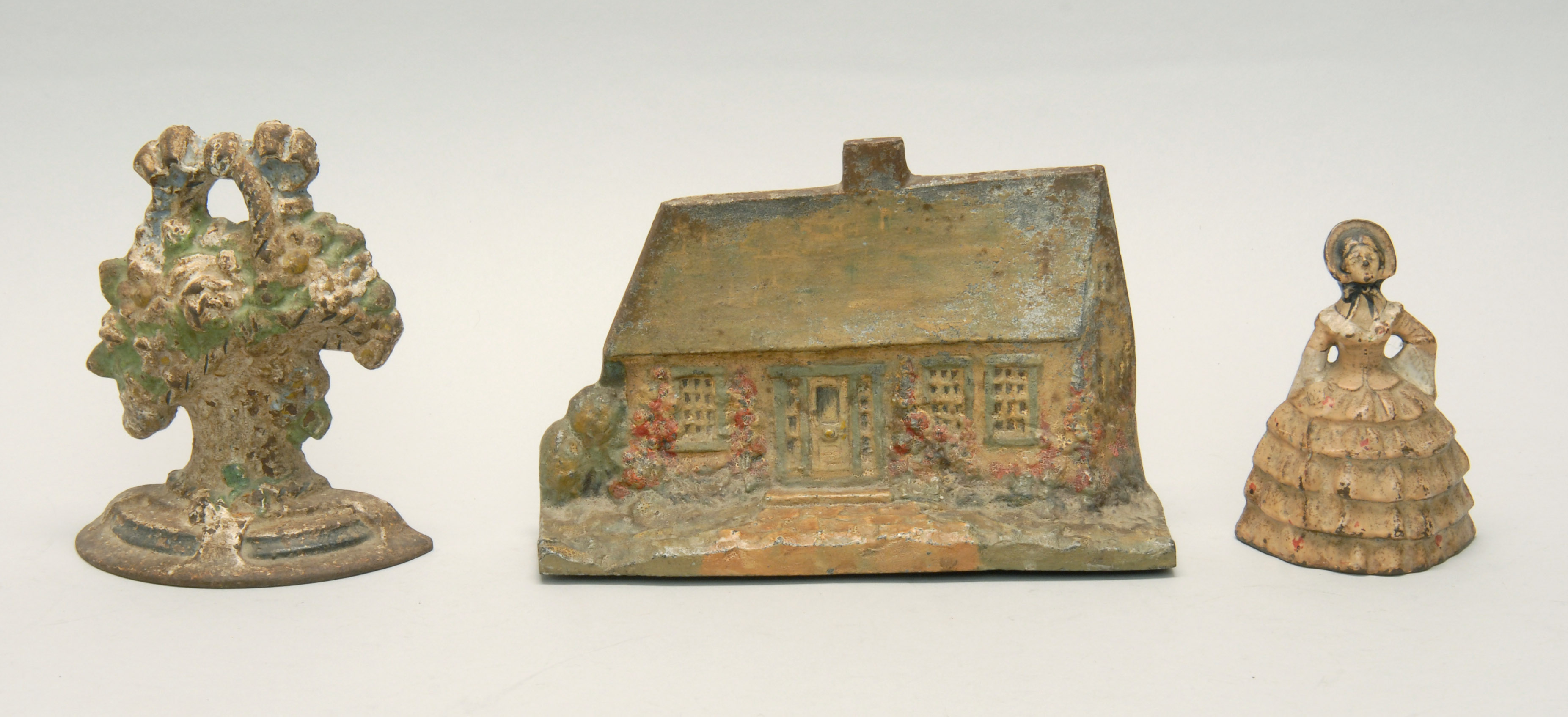 Appraisal: THREE CAST IRON DOORSTOPS Late th Early th Century In