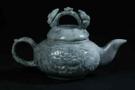 Appraisal: CHINESE MOTTLED JADE TEA POT Ruyi sceptre-form handle floral decoration