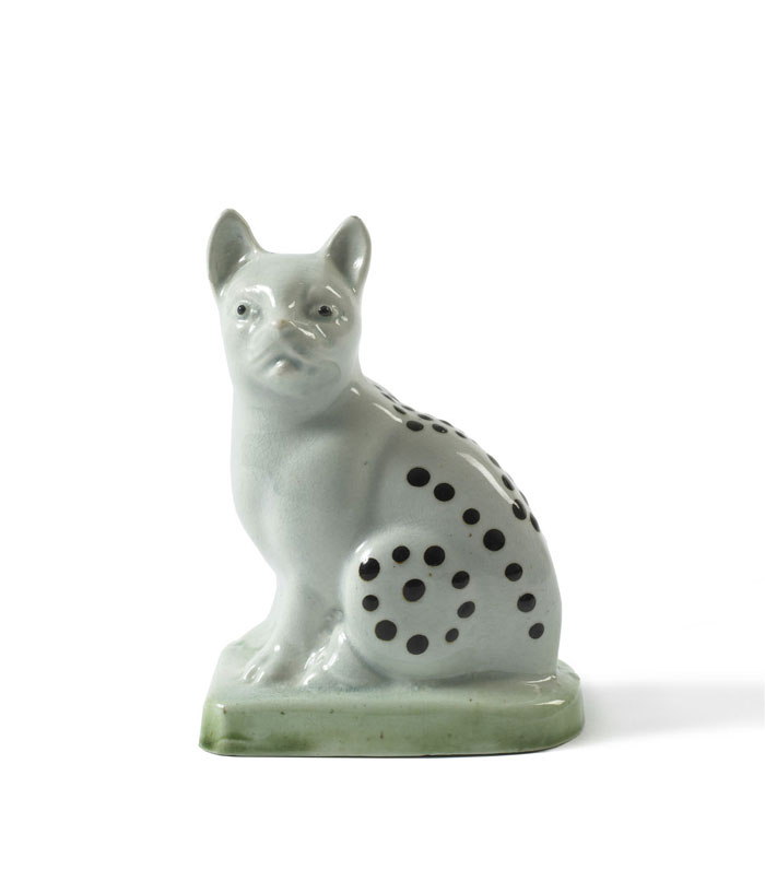 Appraisal: STAFFORDSHIRE PEARLWARE GLAZED CAT ON GREEN BASE LATE EIGHTEENTH CENTURY