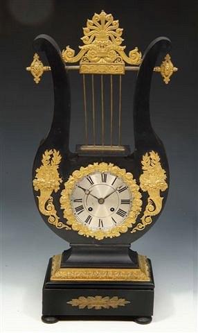 Appraisal: A FRENCH EBONISED LYRE CLOCK with gilt metal mounts Roman