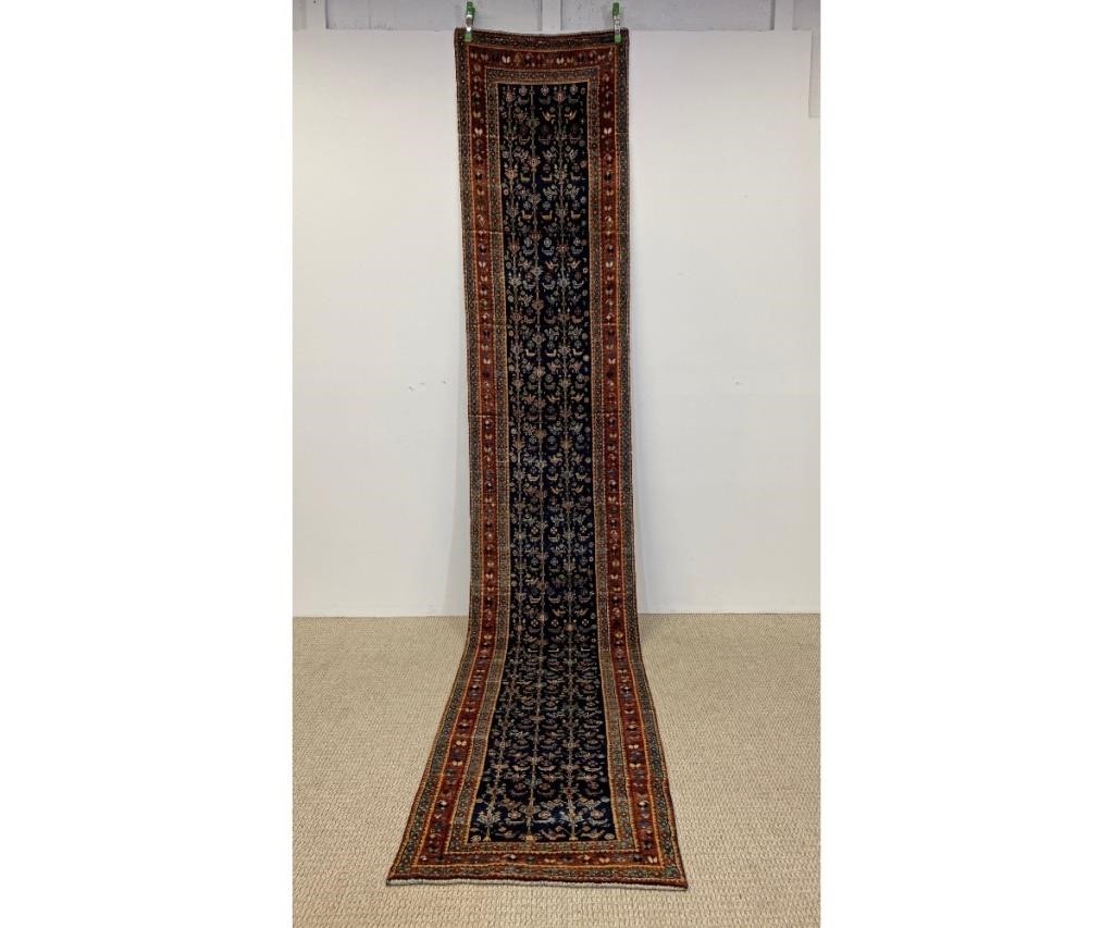 Appraisal: Large Persian hall runner having a blue field stylized animals