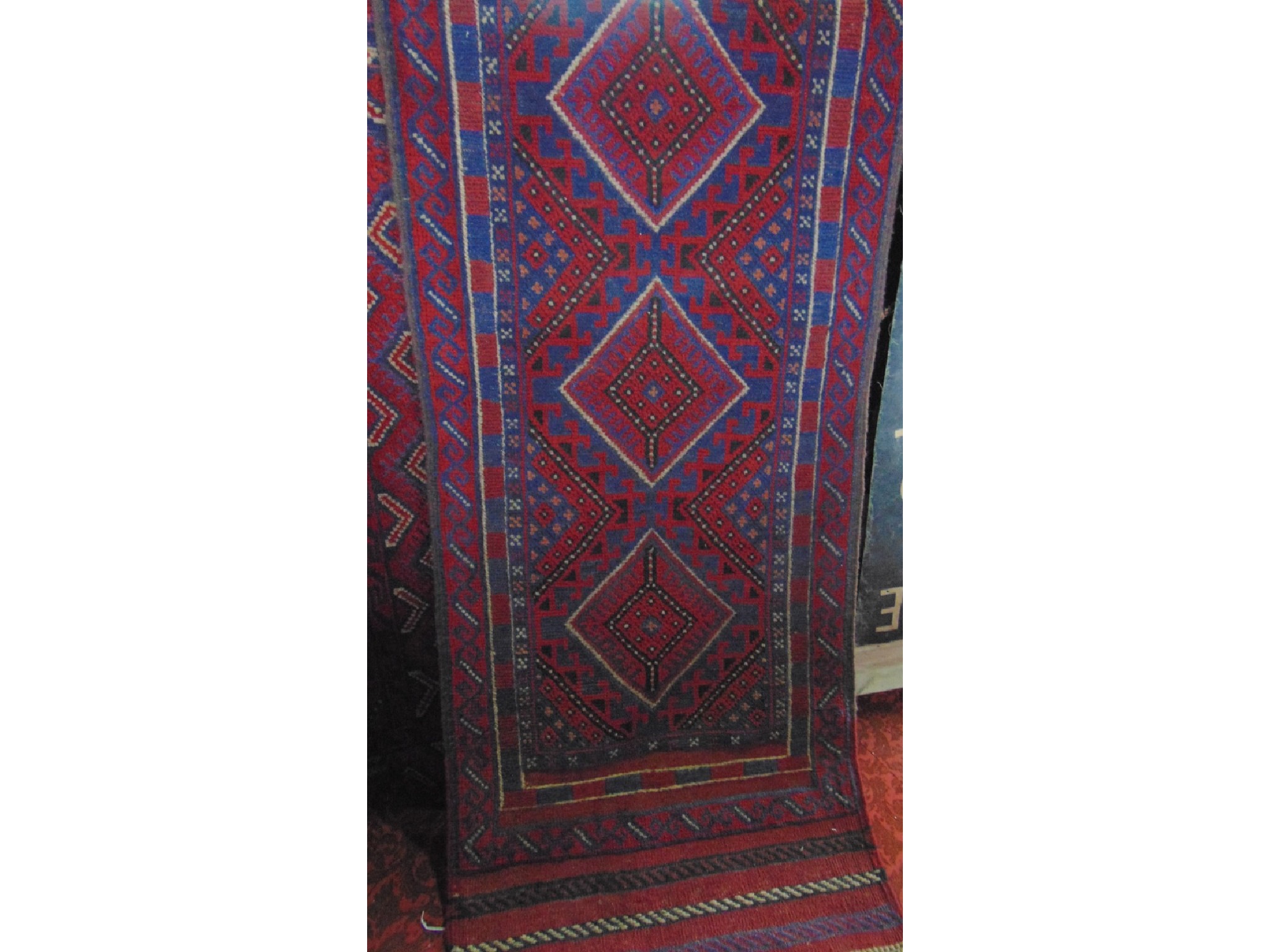 Appraisal: An Eastern style wool runner with multi-medallion centre and set