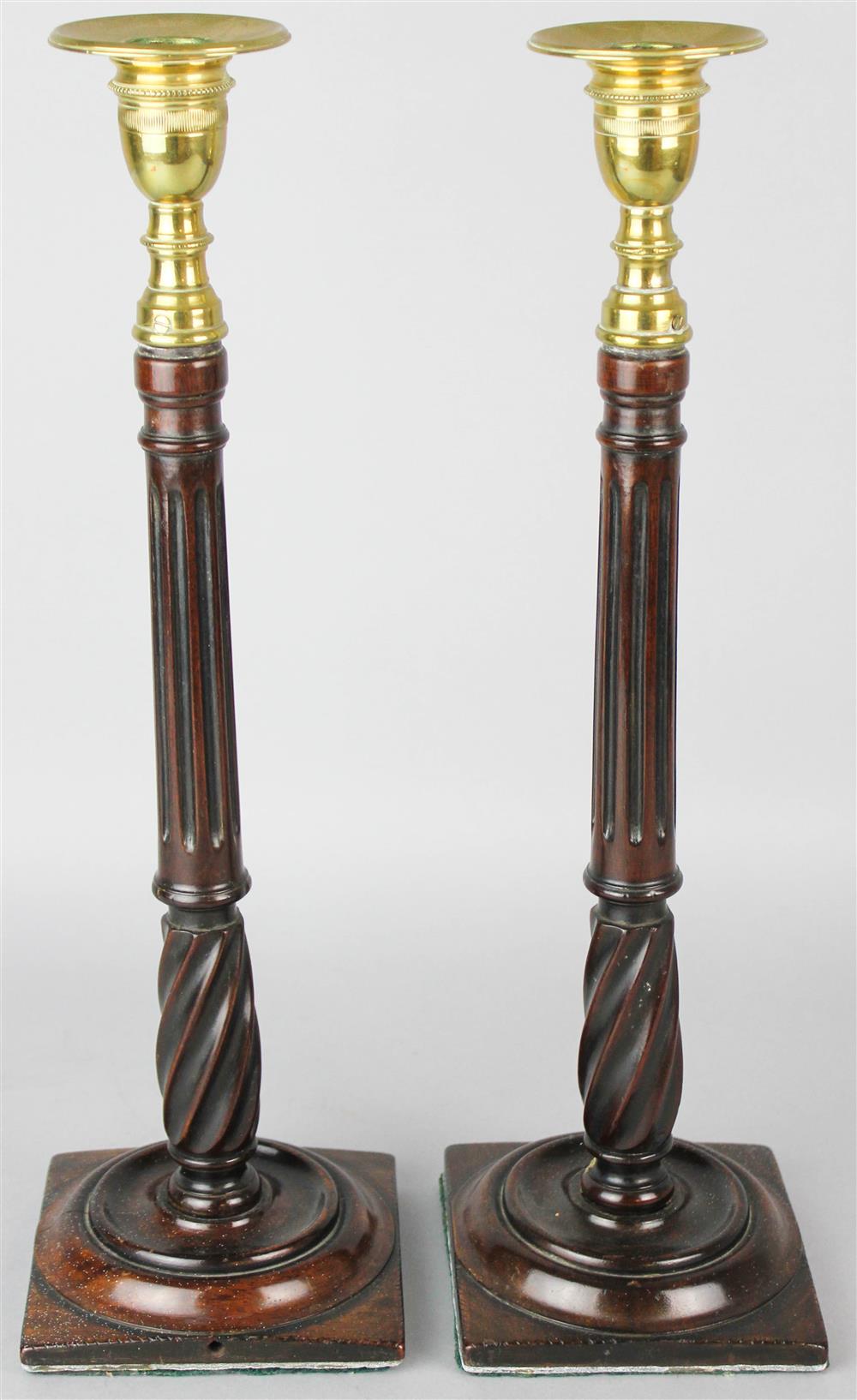 Appraisal: PAIR OF CONTINENTAL MAHOGANY AND BRASS CANDLESTICKS each fitted with