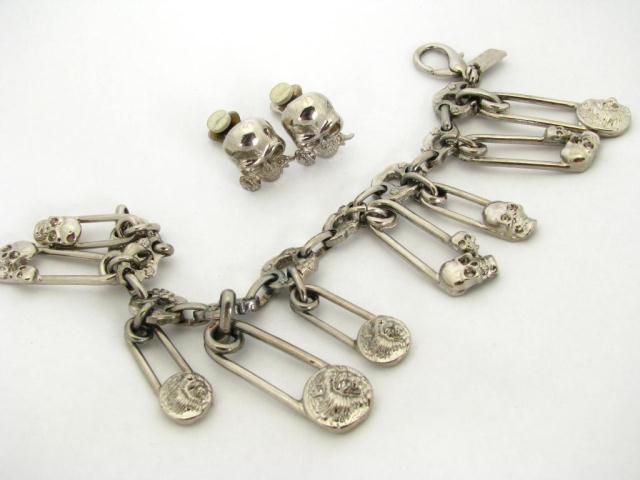 Appraisal: Versus by Gianni Versace '' safety pin lion head skull