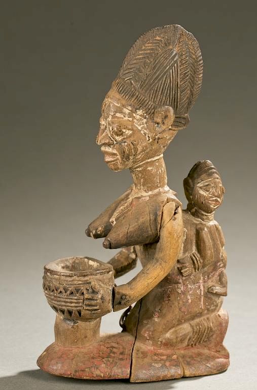 Appraisal: Yoruba maternity figure th century A kneeling maternity figure with