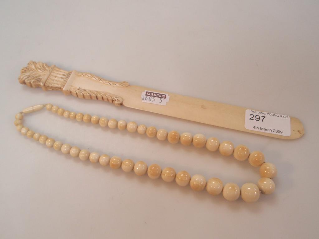 Appraisal: An ivory graduated bead necklace and a page turner