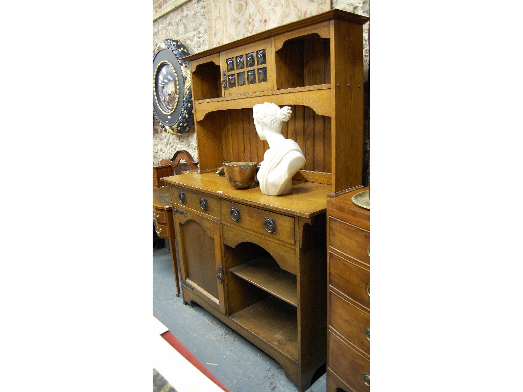 Appraisal: An Arts and Crafts oak dresser with flattened cornice and